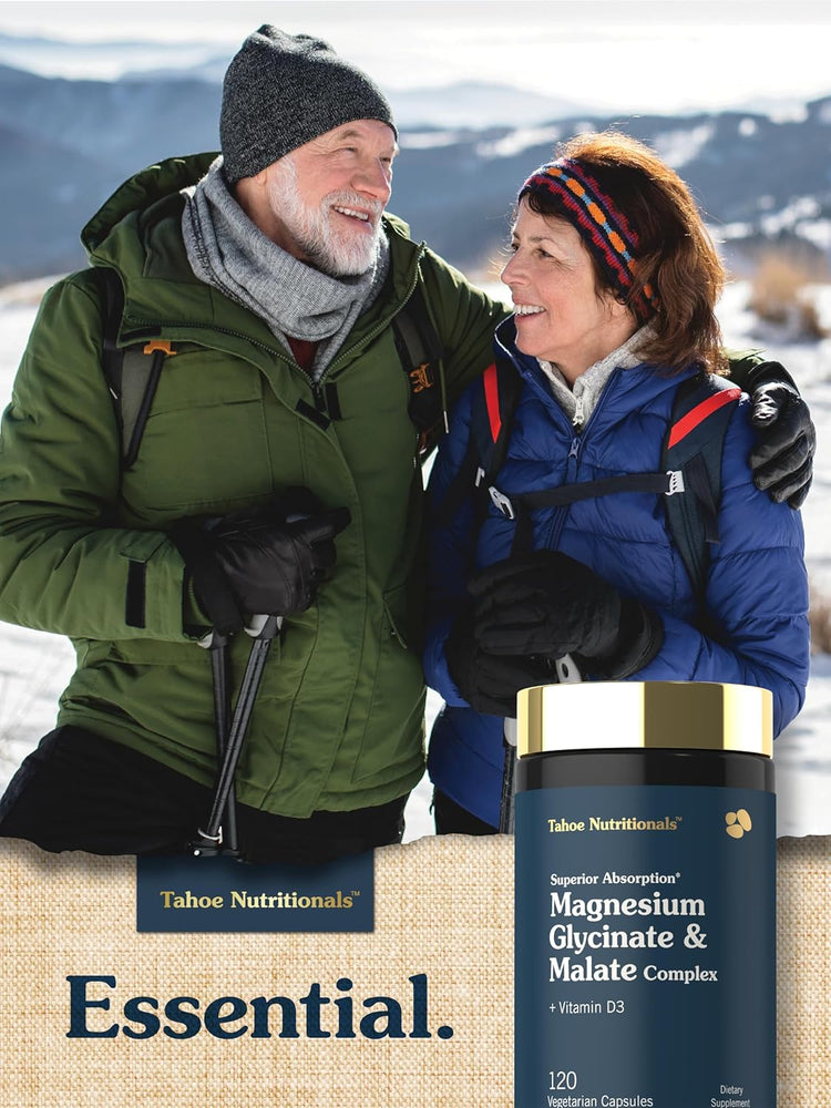 Two older adults hike in a snowy mountain landscape near a Tahoe Magnesium Glycinate & Malate Complex bottle.