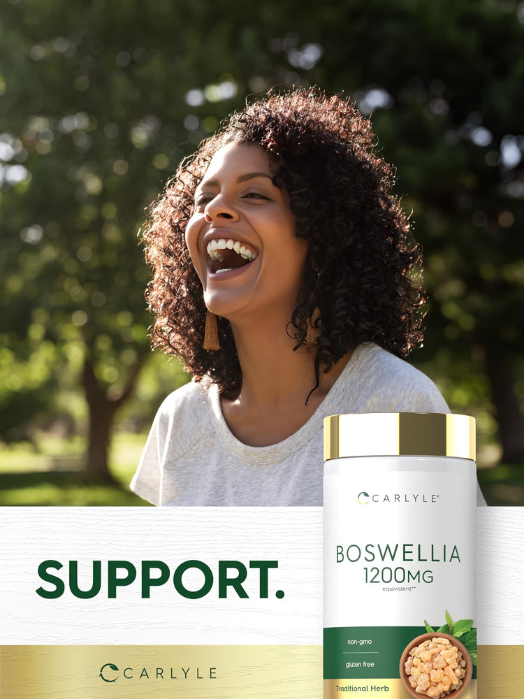 A smiling Black woman laughs outdoors next to a Carlyle Boswellia bottle.