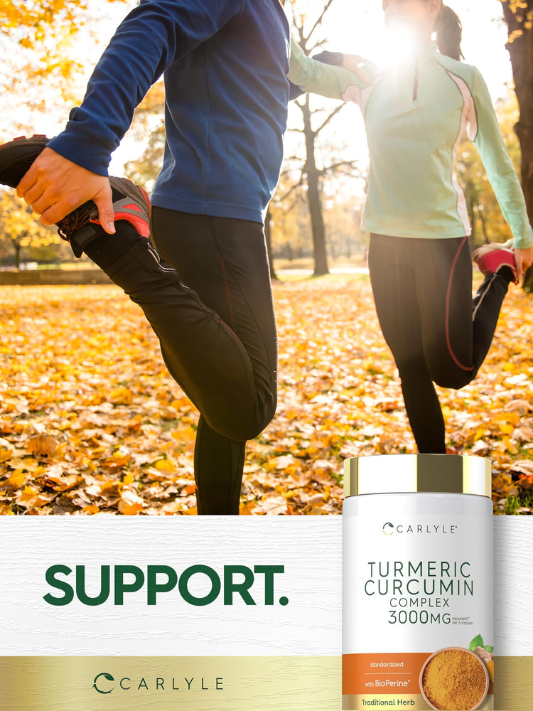Two adults stretch their legs in an autumn park beside a Carlyle Turmeric Curcumin Complex bottle, promoting health.