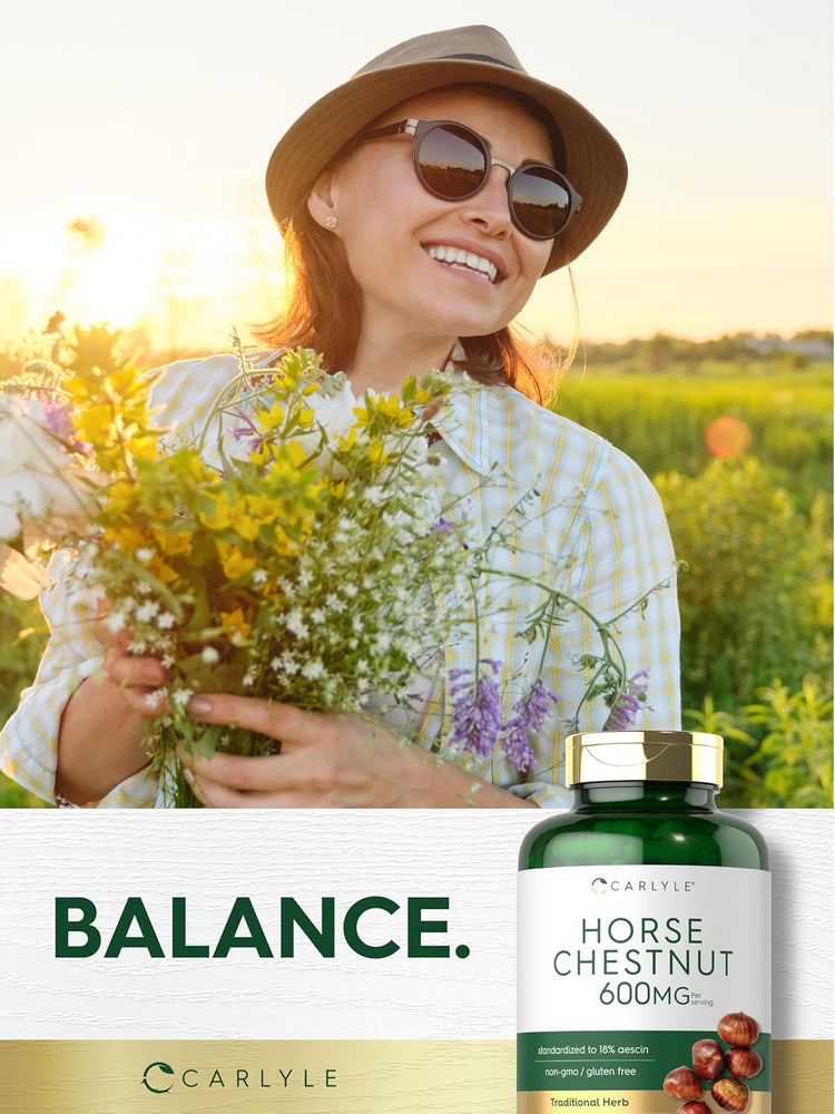 A middle-aged woman smiling while holding a bouquet of wildflowers in a sunny field with a Carlyle Horse Chestnut bottle.