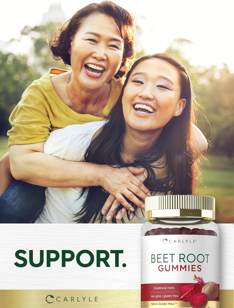 Two smiling Asian women enjoy a piggyback ride outdoors next to Beet Root Gummies, embracing joy and health together.