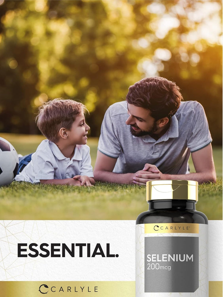 A man and boy lying on grass with a football and a Carlyle Selenium 200mcg bottle between them, gazing at each other.