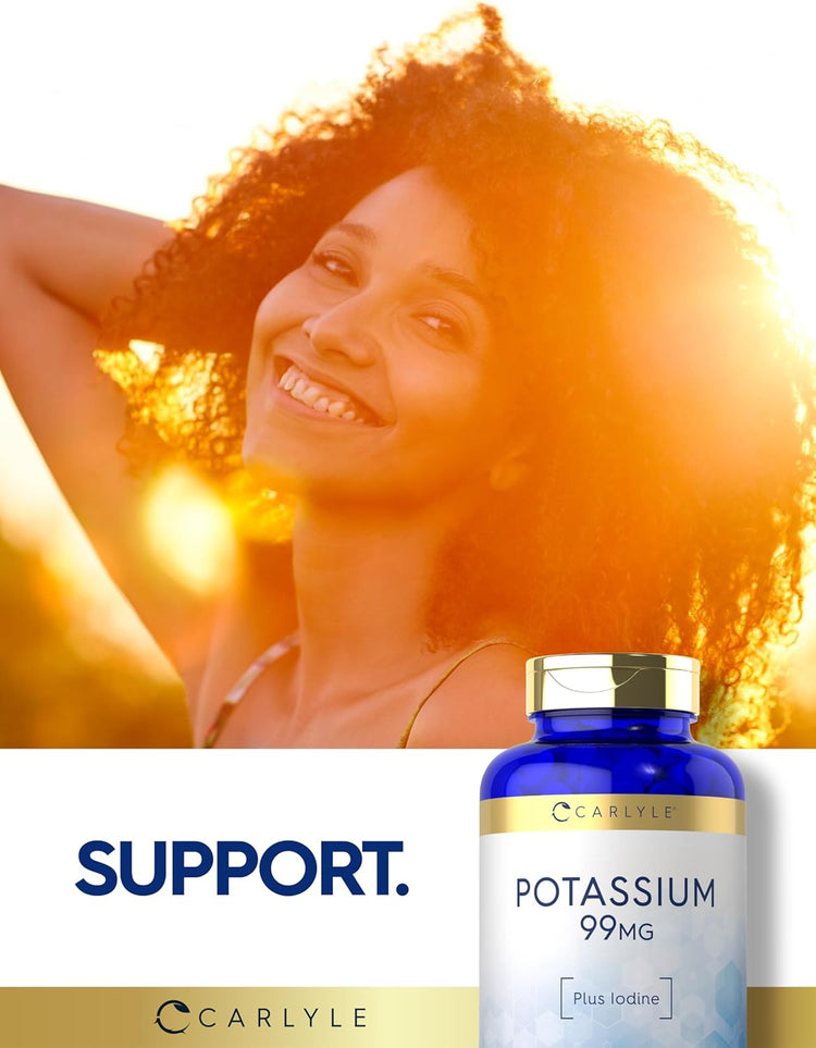 A smiling young woman enjoys the sunshine outdoors next to a Carlyle Potassium bottle.