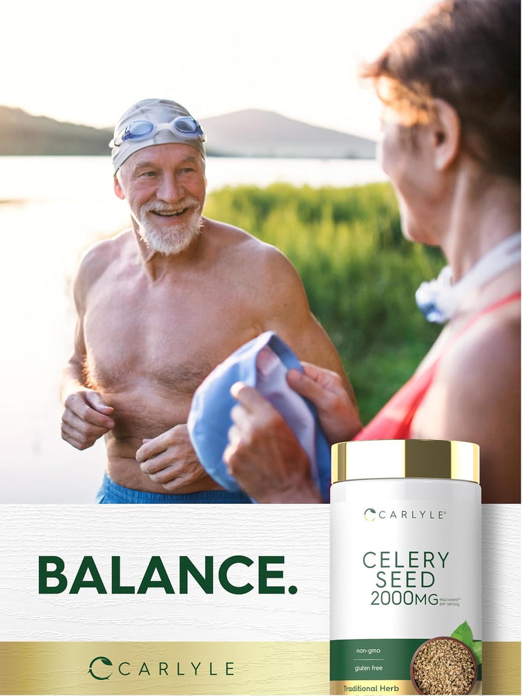 Older man in swim cap and goggles smiles by a lake, receiving a towel from an older woman, with a Celery Seed bottle nearby.
