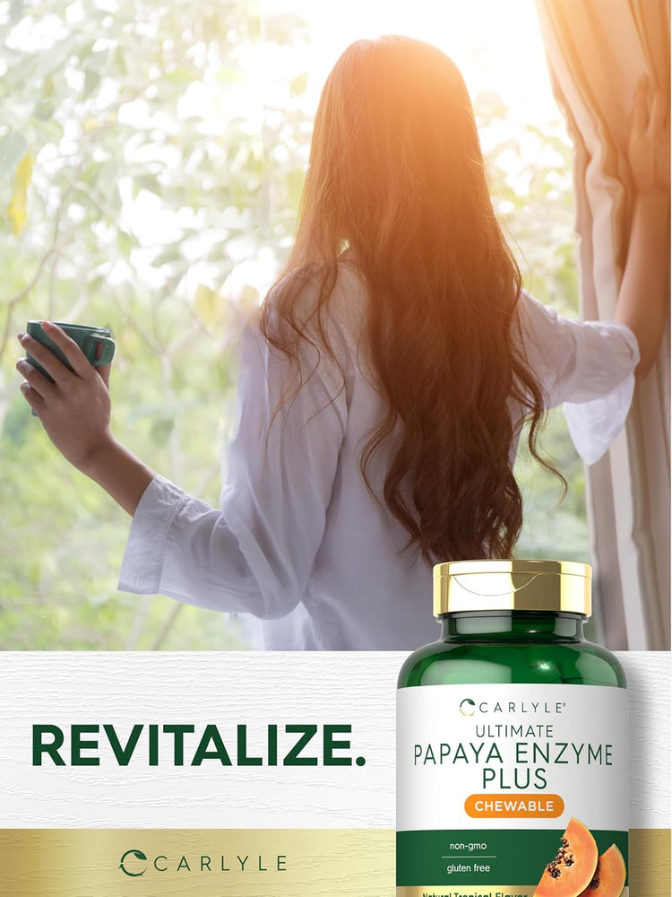 A young woman looks out a sunlit window, holding a mug next to a Carlyle Papaya Enzyme bottle.