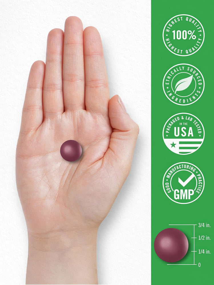 A maroon round gummy, about 1/2 inch in diameter, is resting in the palm of a hand.