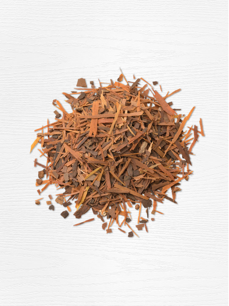 Pile of dried brown bark and wood shavings on a white background