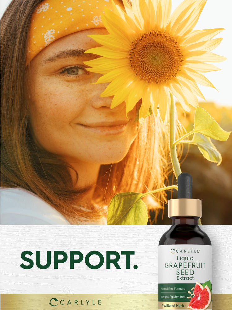 Lifestyle image of woman holding a sunflower with Liquid Grapefruit Seed Extract bottle nearby and graphic stating SUPPORT.