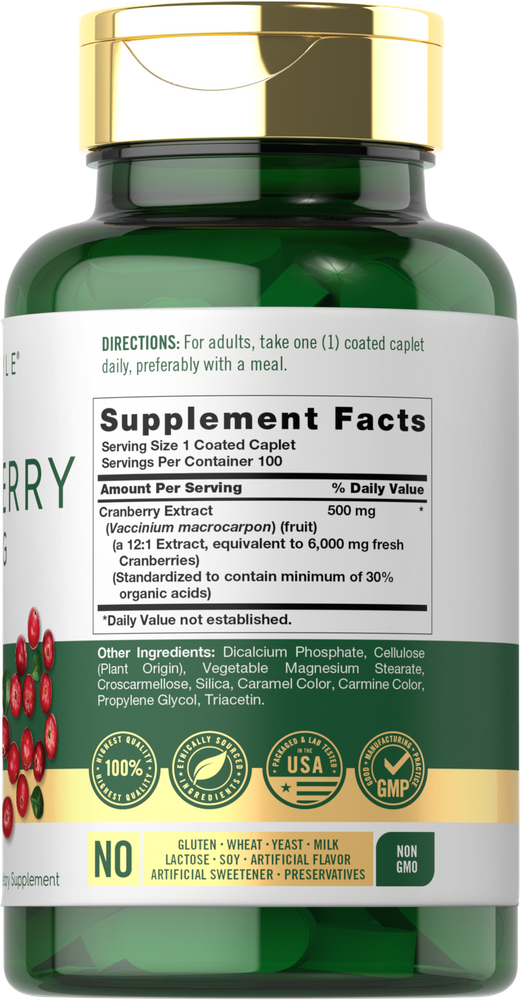 A hand holding a scale with 500mg cranberry coated caplets.