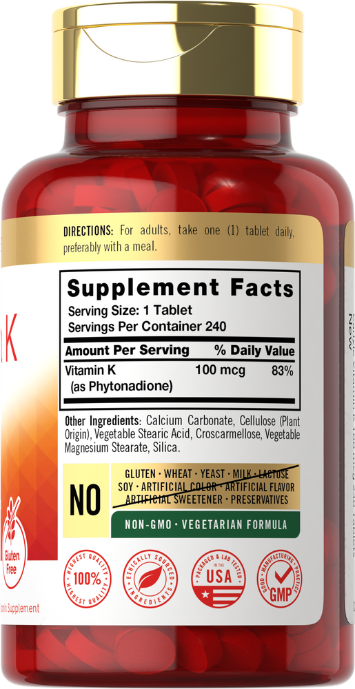 A bottle of Vitamin K tablets, 100 mcg strength, with a total of 240 tablets, shown on a hand-scale for size comparison.