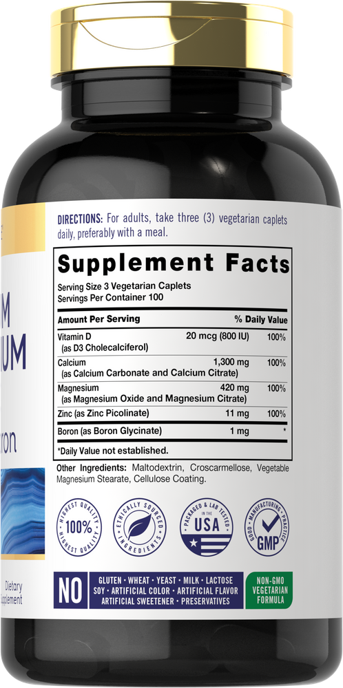 Hand holding a bottle of Carlyle Cal Mag Zinc with D3 and Boron, containing 300 caplets for nutritional support.
