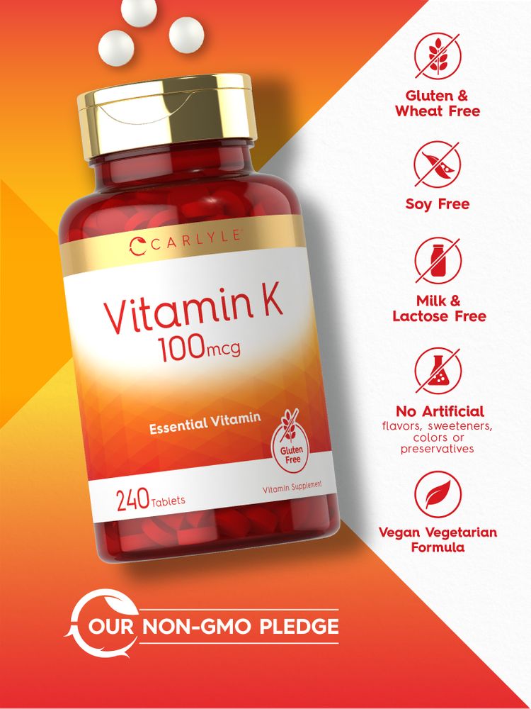 Three round white tablets marked as Vitamin K 100mcg displayed on a bulk scale, highlighting dosage.