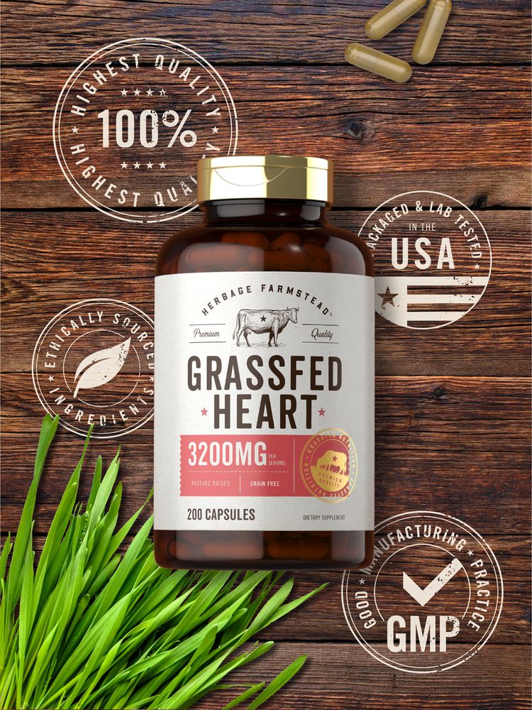 Image of hand holding three light brown capsules for Grassfed Heart supplement.