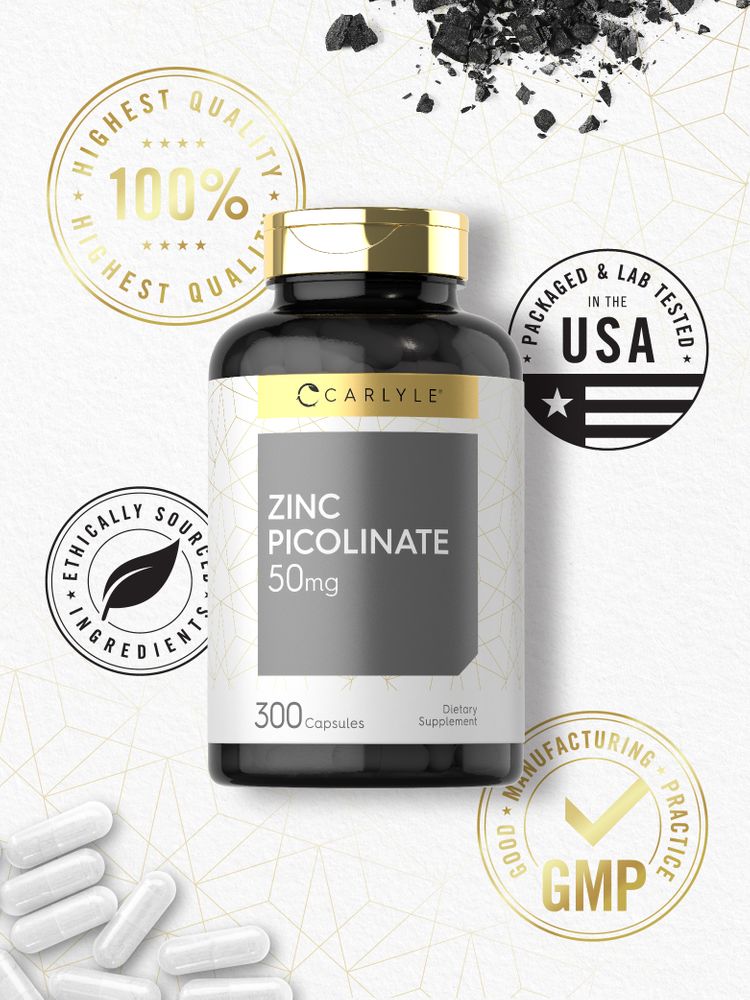 A hand holding white Zinc Picolinate 50 mg capsules.