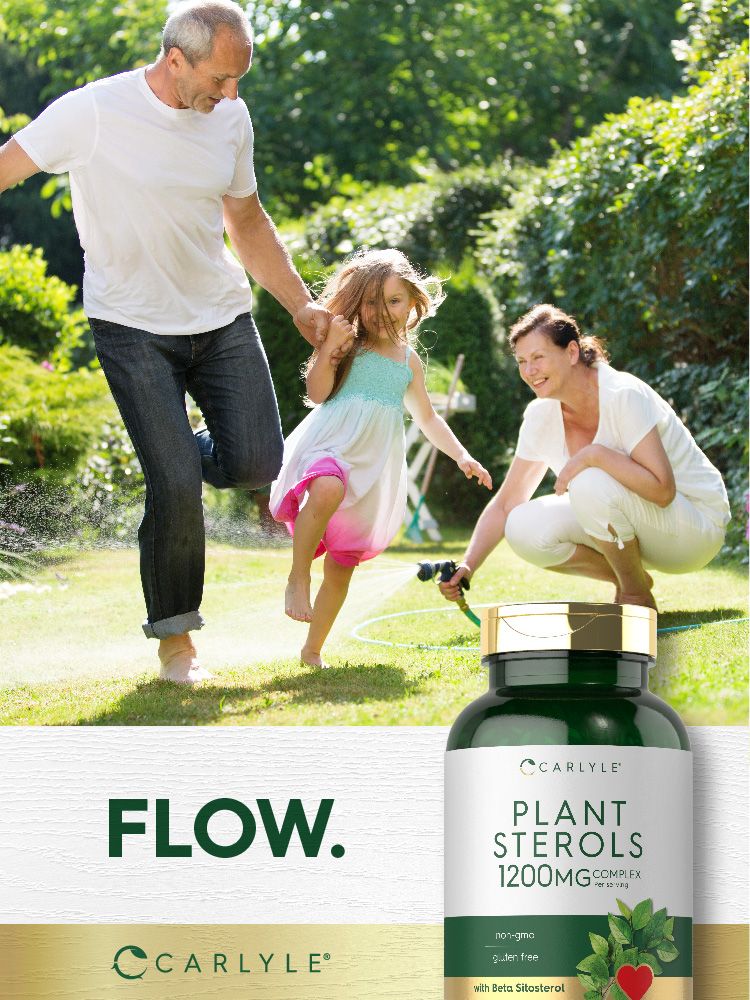 Family playing in a sunny garden with a water hose near a bottle of Plant Sterols.