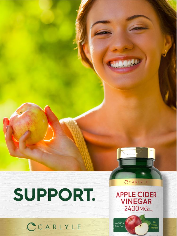 A young woman smiles and holds an apple next to a Carlyle Apple Cider Vinegar bottle.