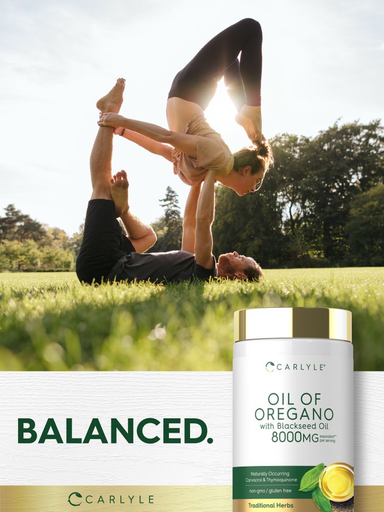 Man and woman perform acroyoga in a park. A Carlyle Oil of Oregano bottle is visible in the foreground.