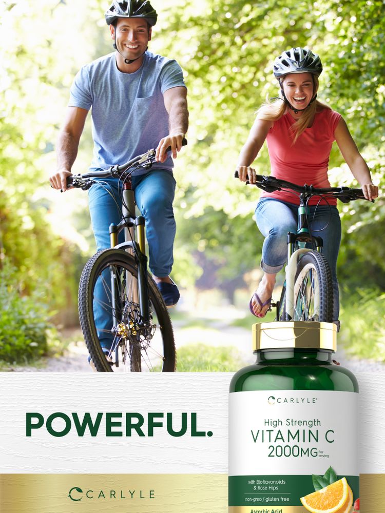 Young man and woman ride bikes on a path, showcasing a Carlyle Vitamin C bottle.