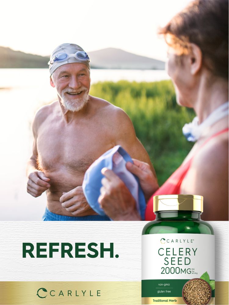 Senior man in swim cap and goggles, smiling and holding a towel by a lake, facing a woman, with Carlyle Celery Seed bottle.