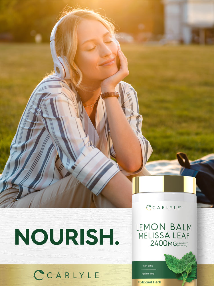Young woman relaxing outside, listening to music with headphones, next to a Carlyle Lemon Balm Melissa Leaf bottle.