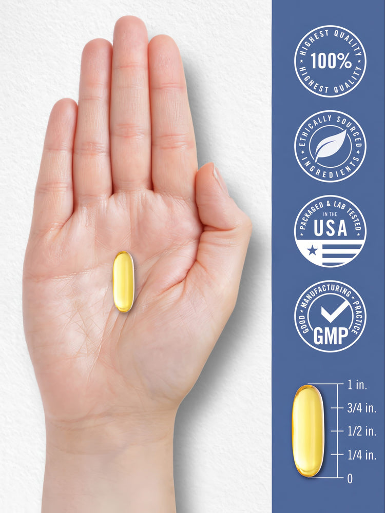 A yellow softgel on a hand, about 1 inch long, showing size.