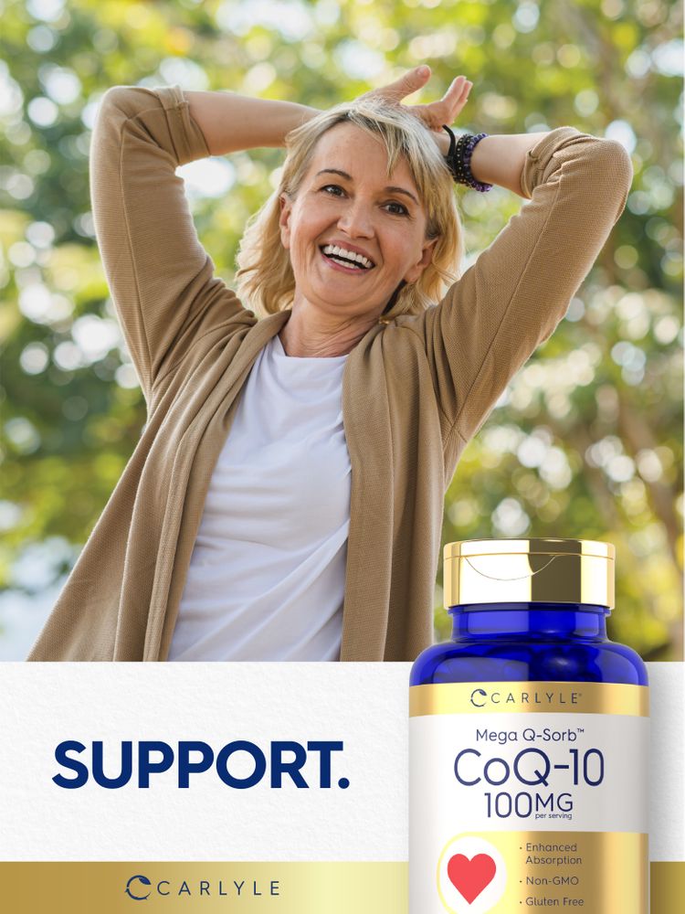 A smiling middle-aged woman outdoors with hands behind her head beside a Carlyle CoQ-10 bottle.