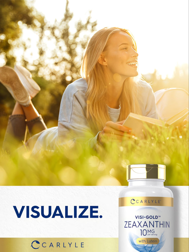 Young woman lying in grass reading a book with a Carlyle Zeaxanthin bottle beside her, enjoying a peaceful day.