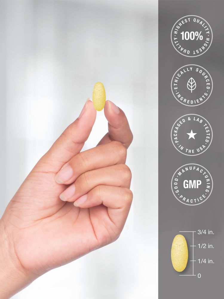 A hand holds a yellow oval capsule, measuring 3/4 inch in length, against a neutral background.