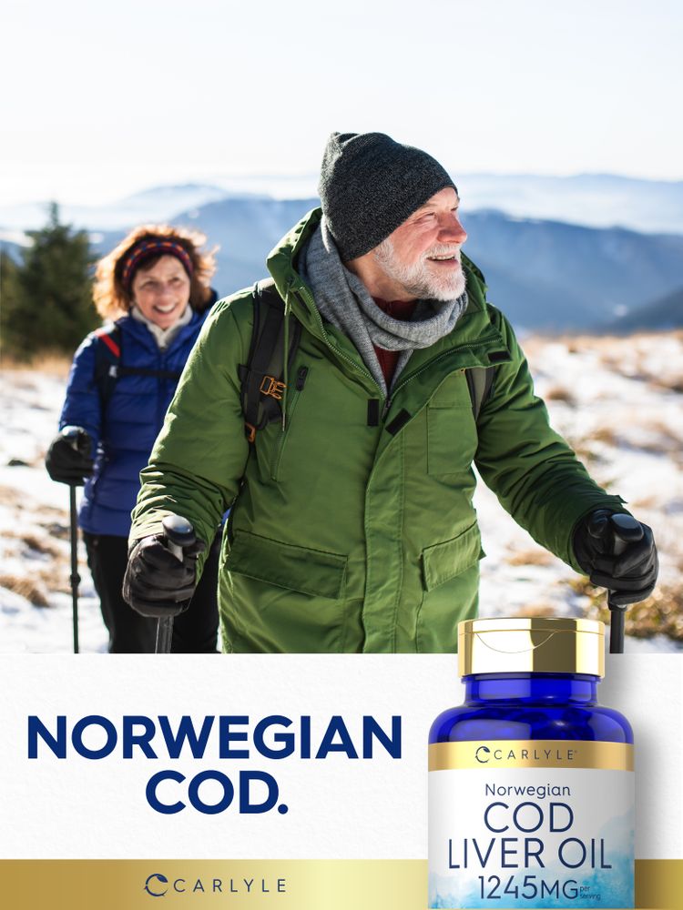 An older man and woman hiking in a snowy mountain landscape holding a bottle of Norwegian Cod Liver Oil.