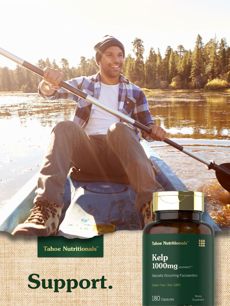 A man kayaking on a lake holds a Tahoe Nutritionals Kelp bottle.