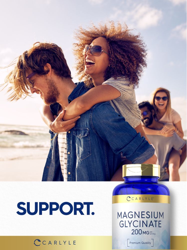 Young adults laughing and giving piggyback rides on a beach with a Carlyle Magnesium Glycinate bottle nearby.