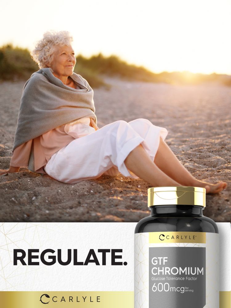 Senior woman sitting on a sandy beach at sunset, next to a Carlyle GTF Chromium bottle.