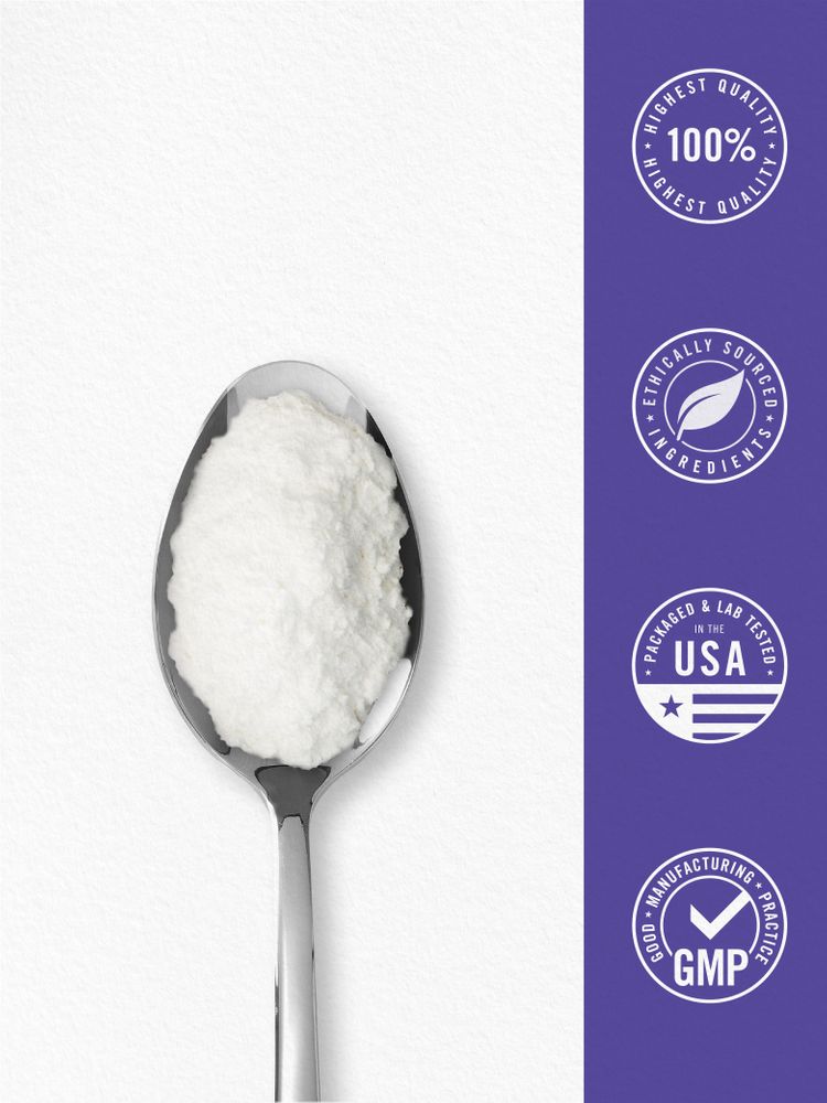 A hand holds a spoonful of white powder, likely a supplement or ingredient, over a kitchen scale for measurement.