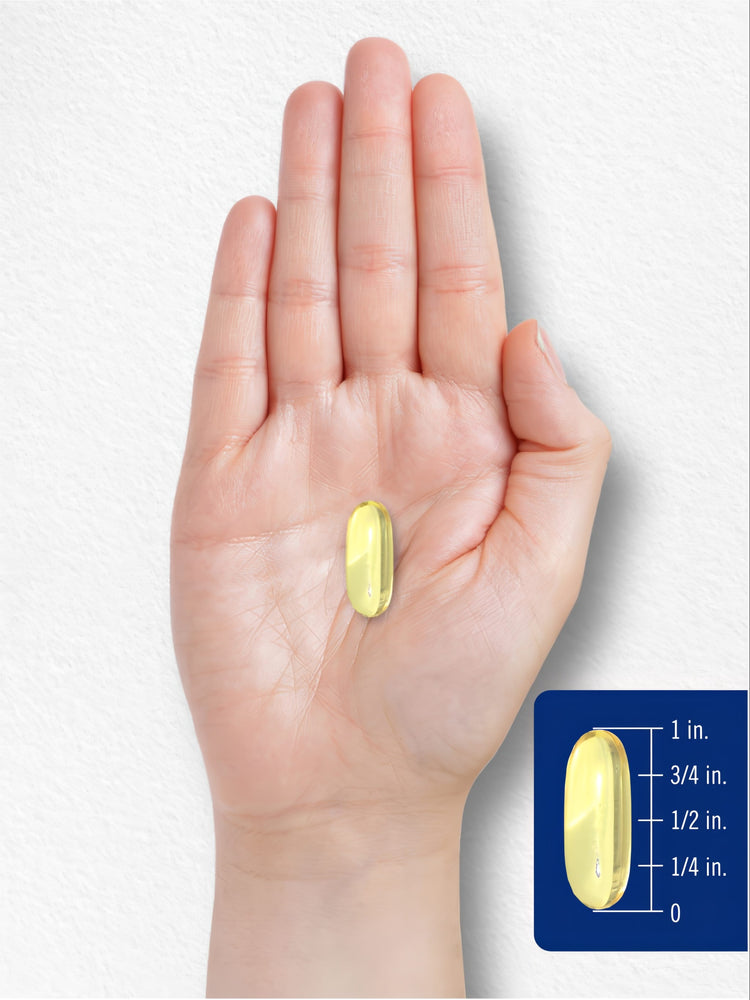 Yellow softgel placed on a hand, featuring a measurement graphic showing it is 3/4 inch long.
