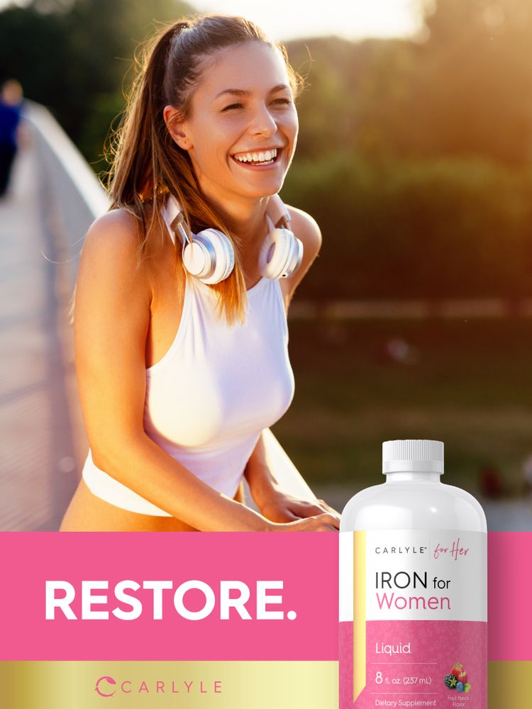 Young woman smiling outdoors with headphones around her neck next to a bottle of Liquid Iron for Women.