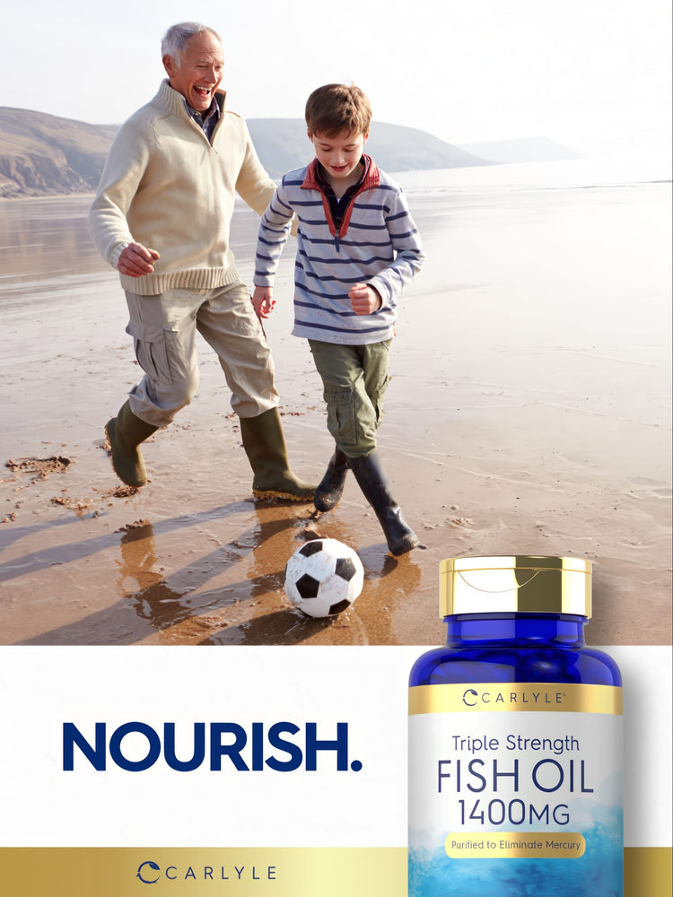 An older man and a young boy play soccer on a beach, with a Carlyle Triple Strength Fish Oil bottle visible.