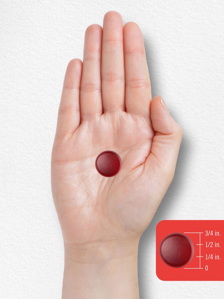 A red gummy candy with a diameter of three-quarters of an inch shown on a hand for scale, indicating its size.