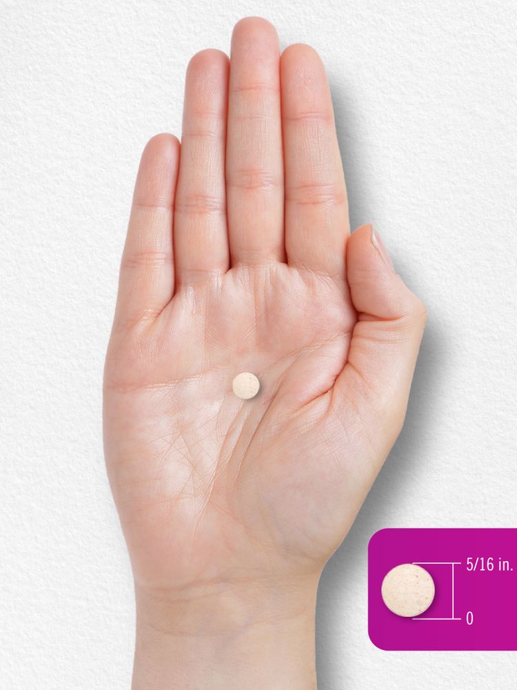 A small, round beige tablet measuring 5/16 inch in diameter rests on an open palm.