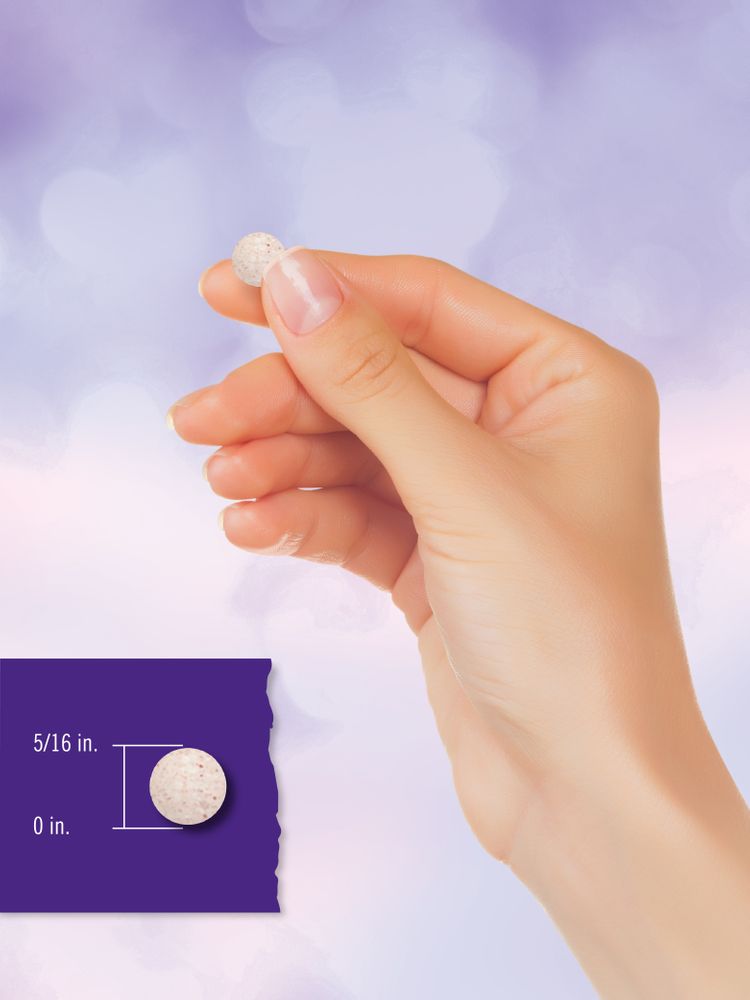 A round, white tablet with specks, measuring 5/16 inch from top to bottom.