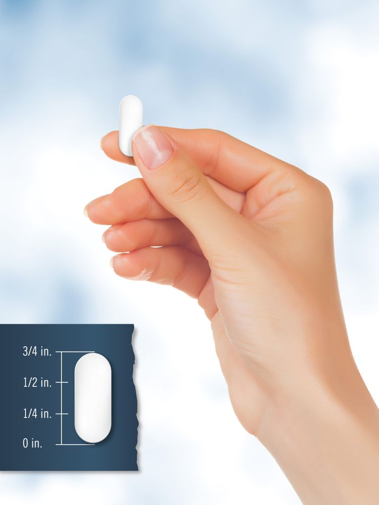 A white oblong tablet, 5/8 inch in length, shown held in a person's hand, possibly for measurement or scale reference.