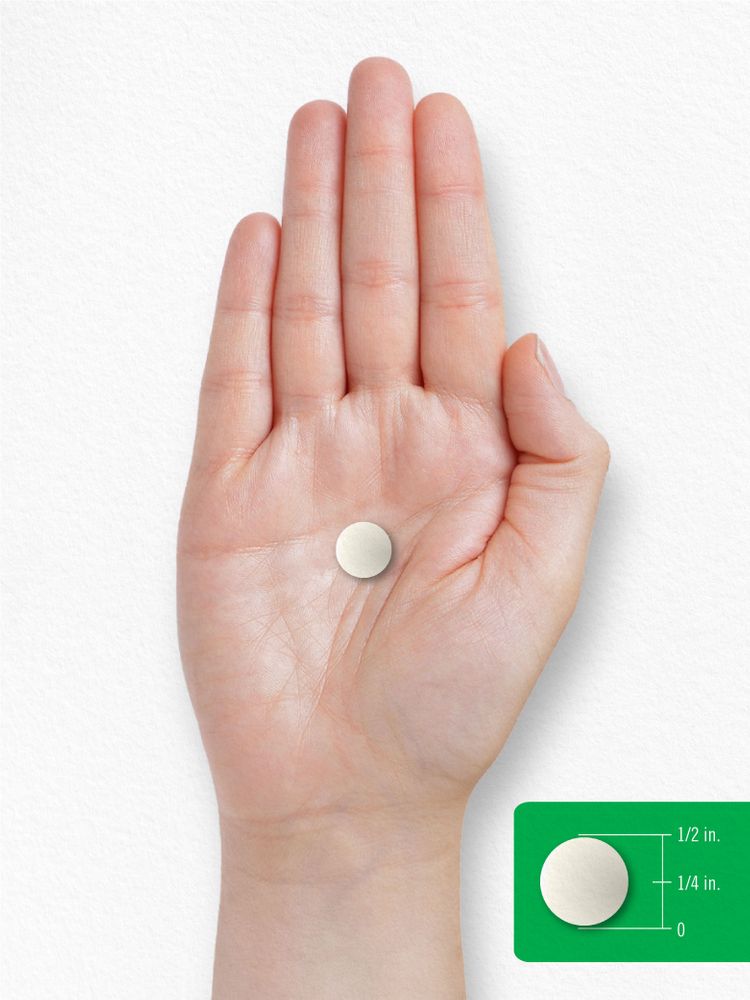 A round, off-white tablet measuring half an inch in diameter is shown on a scale.
