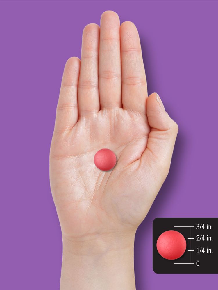 A red gummy on a hand, measuring about 5/8 inch in diameter.
