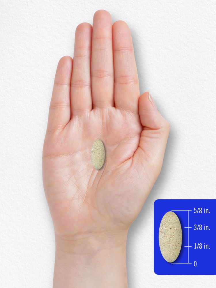A hand holds an oval-shaped tablet, measuring 5/8 inch.