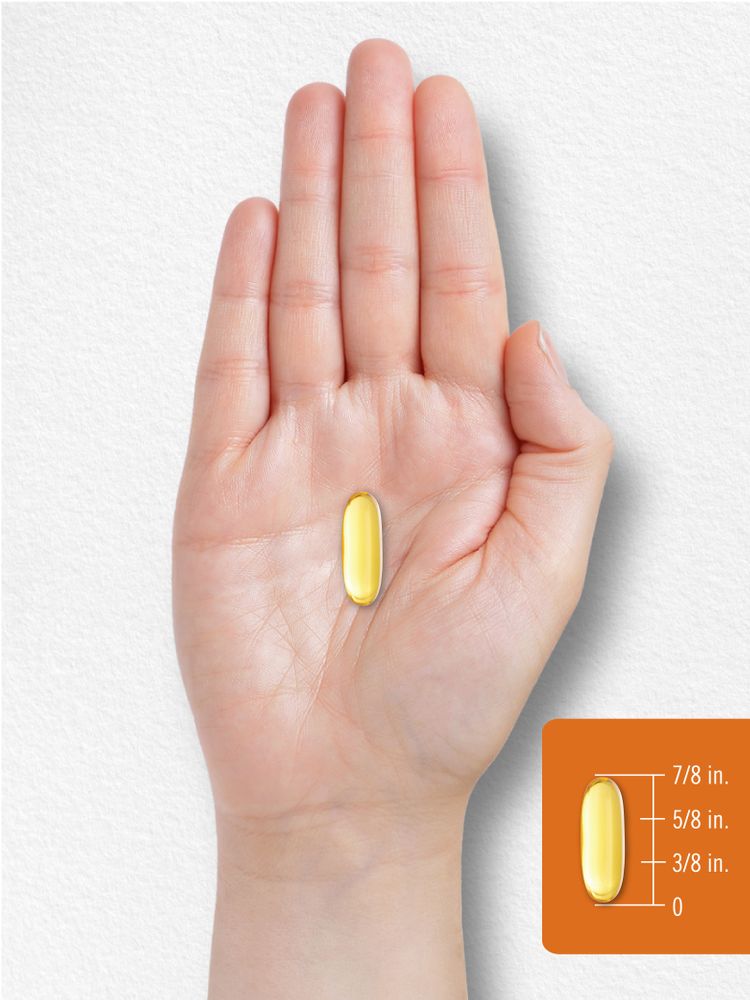 A yellow softgel measuring seven-eighths of an inch long is displayed on a hand scale, highlighting its size.