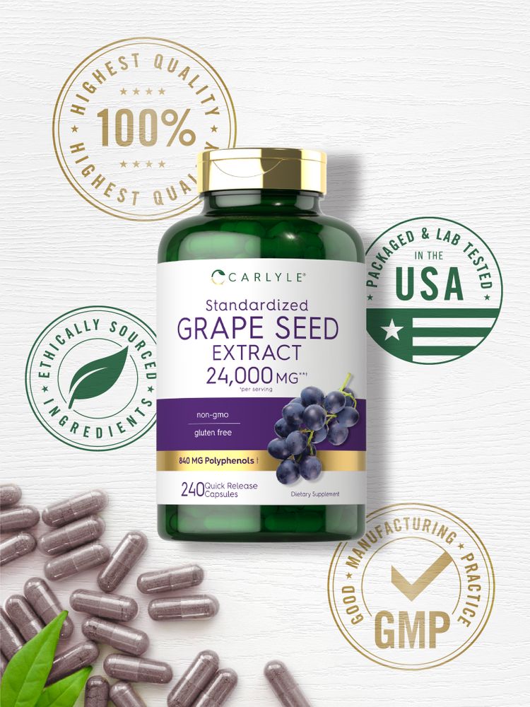Grape Seed Extract 24,000 MG capsules scattered on a white textured surface with green leaves beside them.