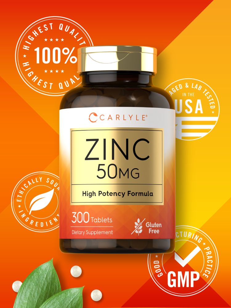 A hand holding three white Zinc 50 mg tablets, emphasizing their size and color against a neutral background.