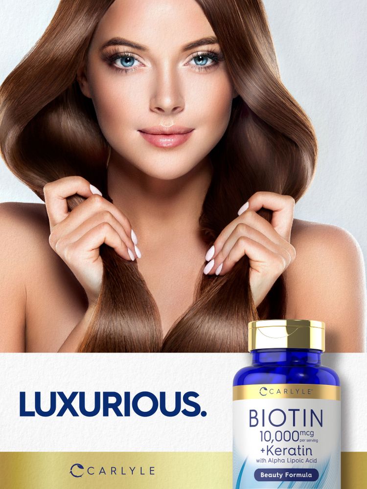 A young woman touches her long brown hair next to a Carlyle Biotin + Keratin bottle.