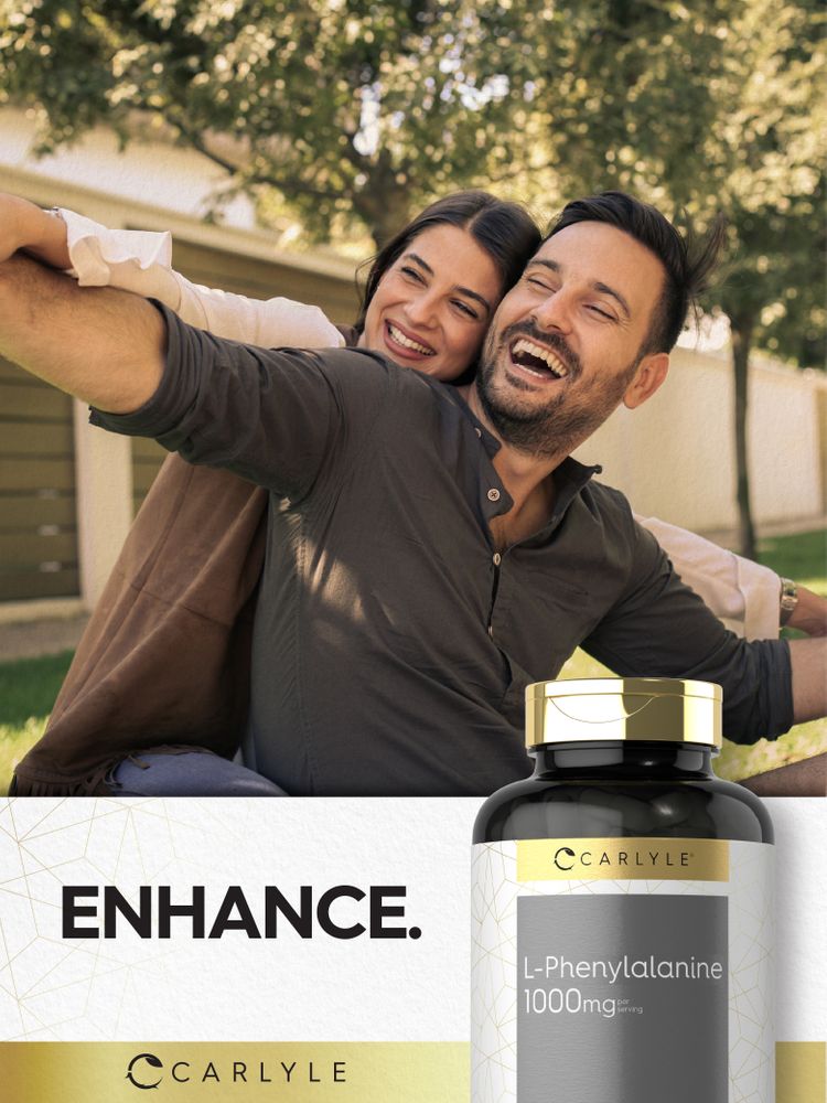 A man and woman laugh and embrace outdoors, holding a bottle of Carlyle L-Phenylalanine 1000 mg.