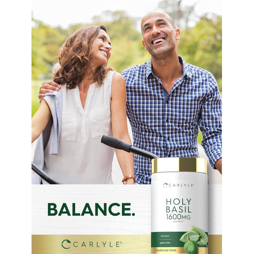 View 6 A smiling couple holds bicycles outdoors, displaying a Carlyle Holy Basil 1600 mg bottle.