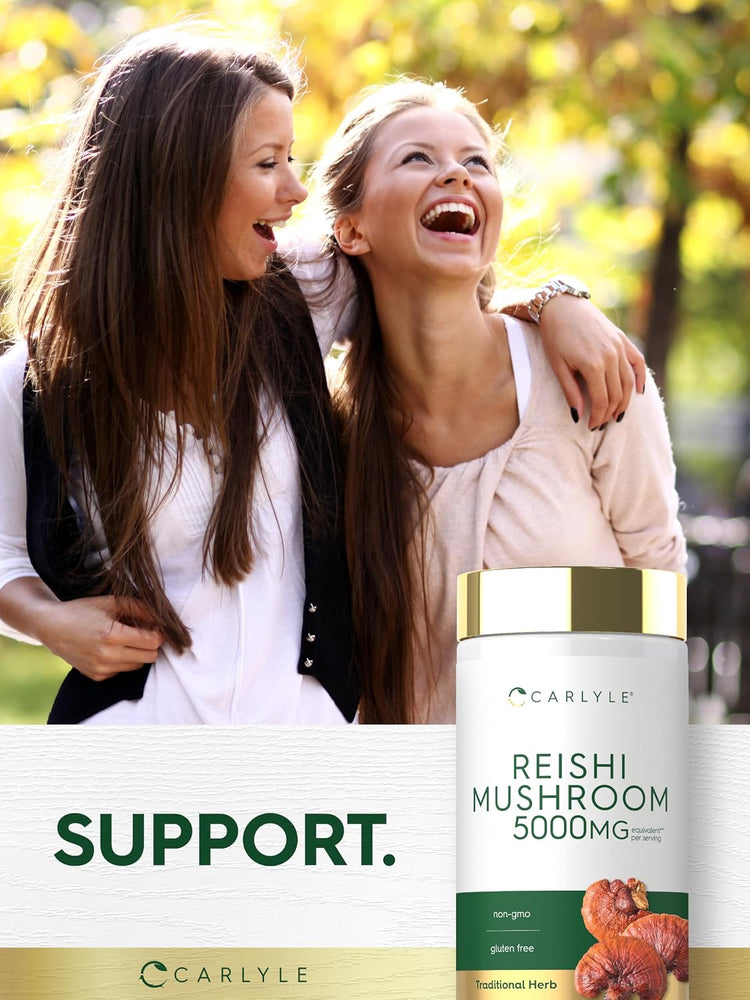 Two young women laughing and hugging outside, holding a Carlyle Reishi Mushroom bottle.